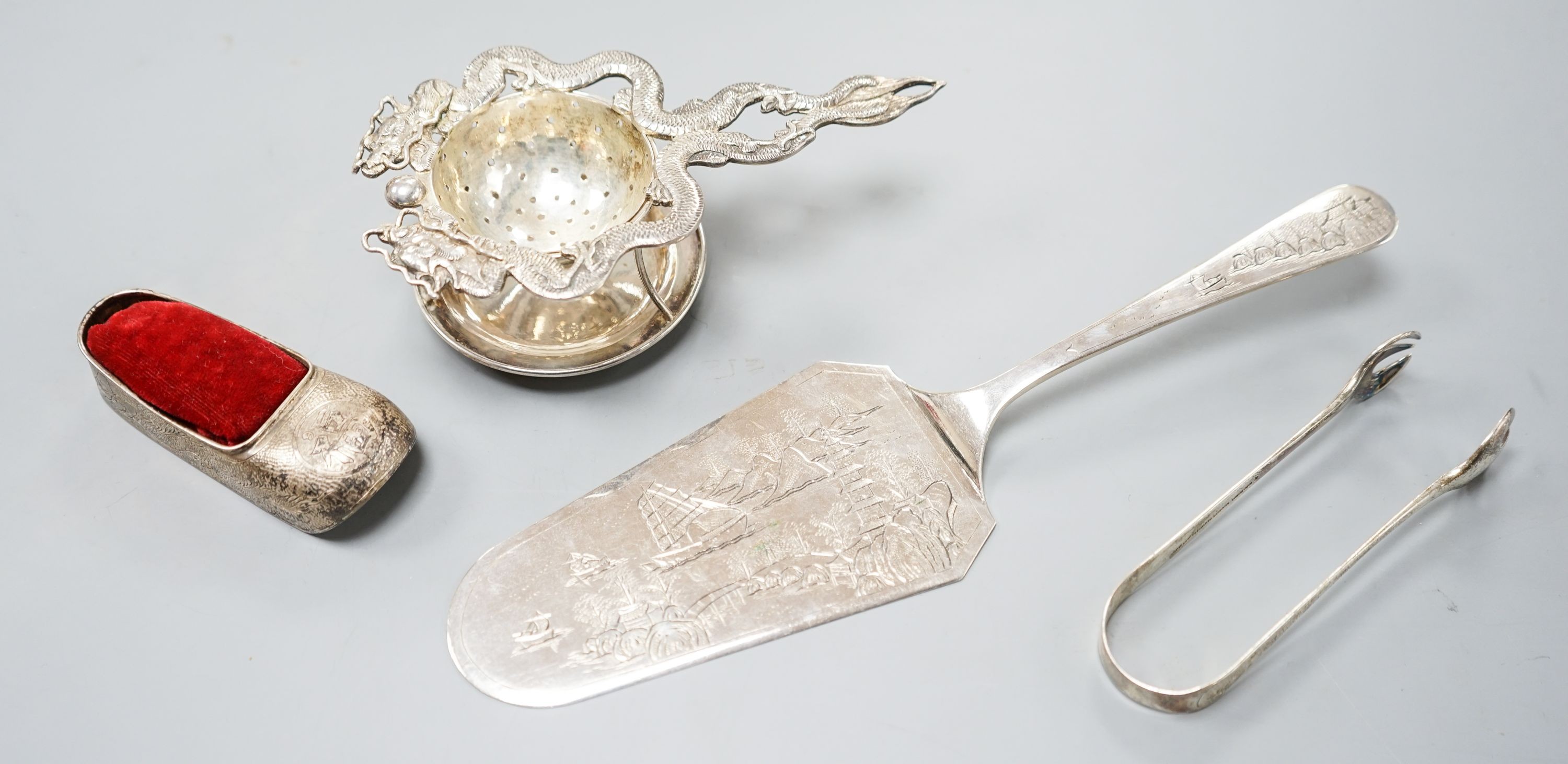 A Chinese white metal cake slice by Tack Hing, 24.4cm and a tea strainer on stand, pair of sugar tongs and pin cushion by Kingsburg, Hong Kong.